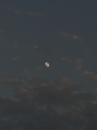 A moody video background showing shifting stars and dark clouds.