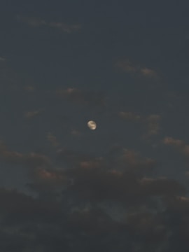 A moody video background showing shifting stars and dark clouds.