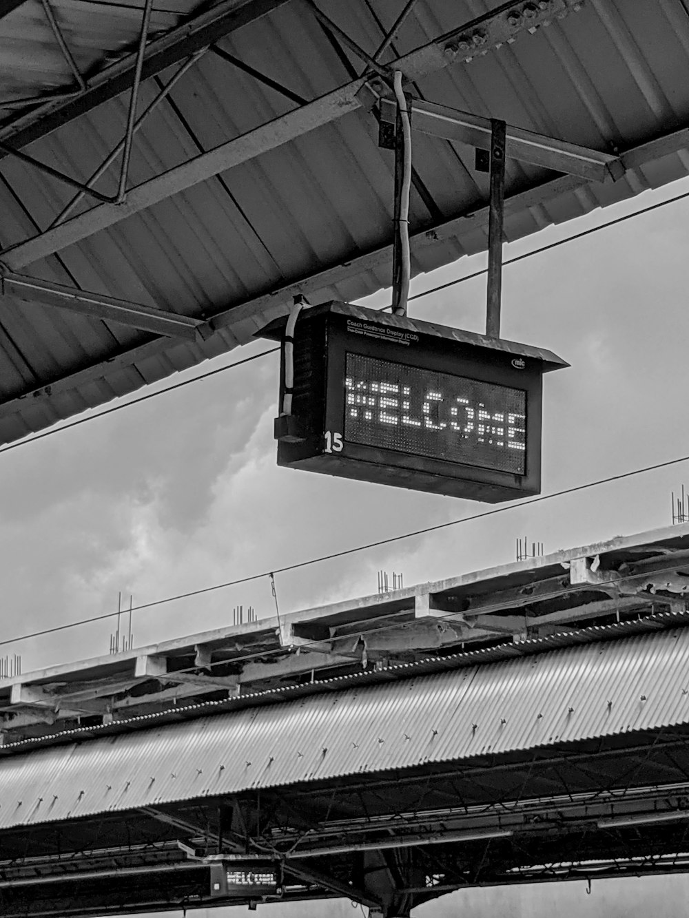 a black and white photo of a welcome sign