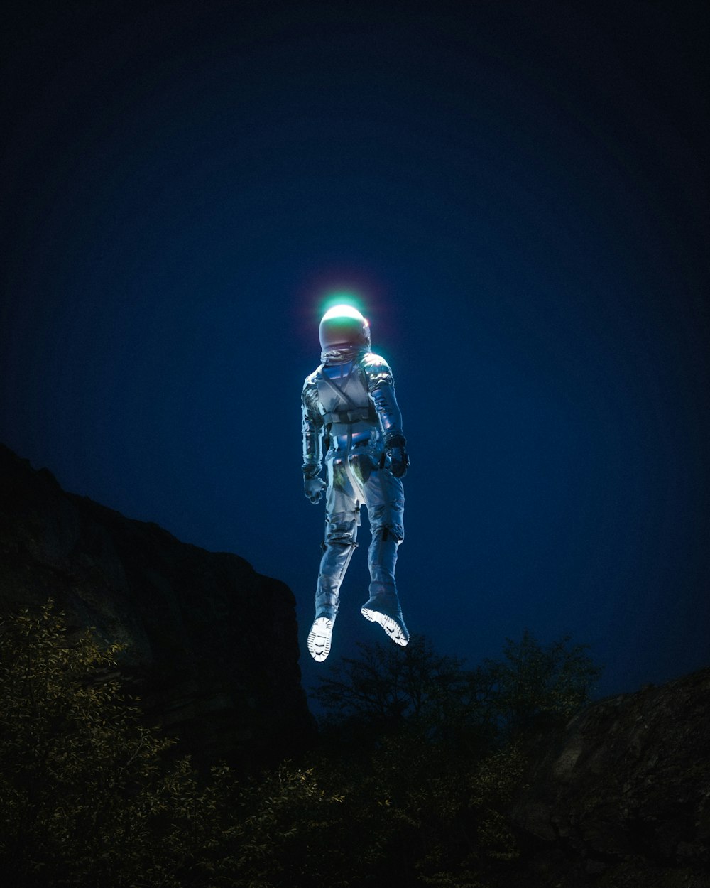 a man in a space suit standing on top of a hill