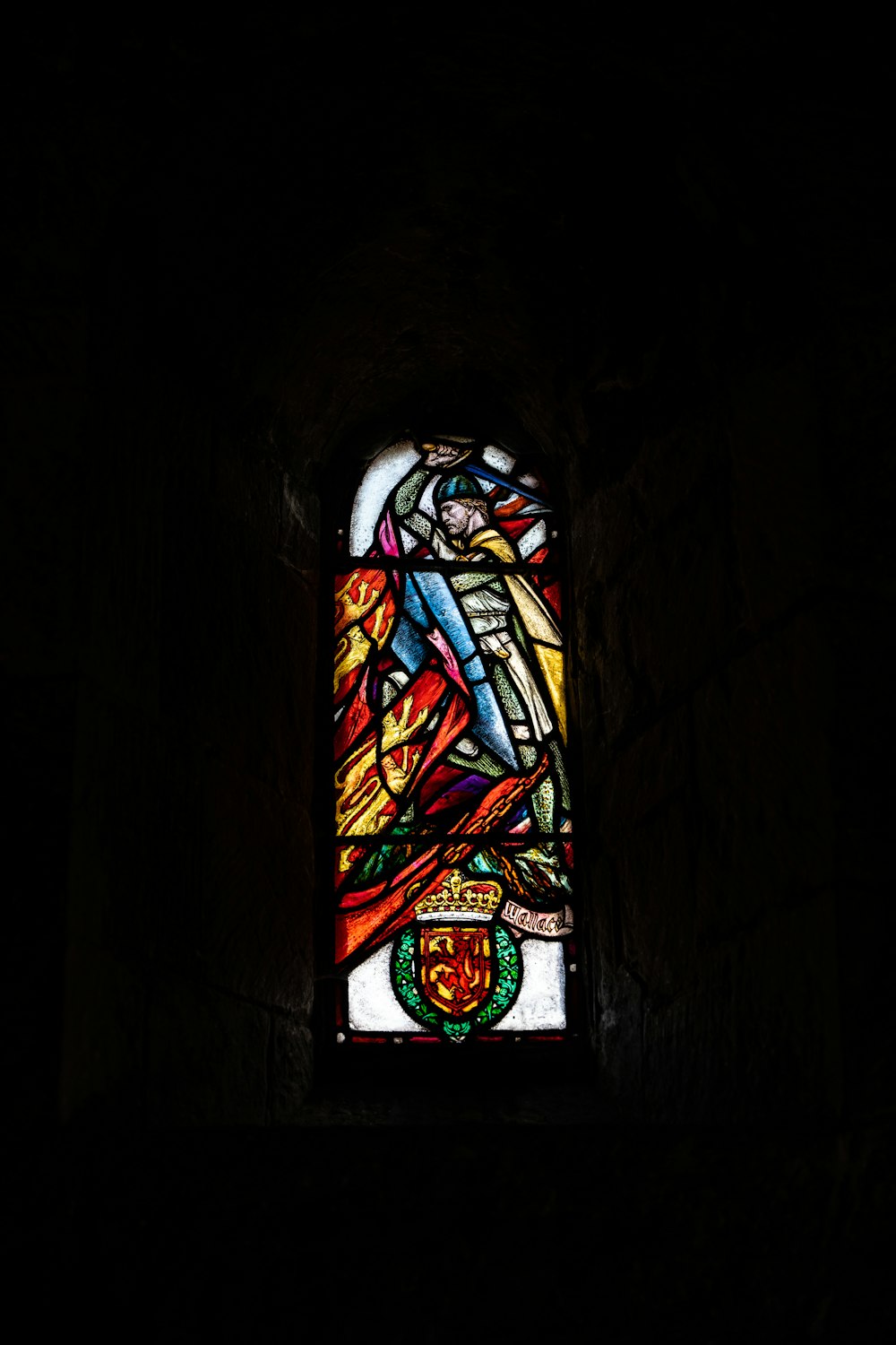 a stained glass window in a dark room