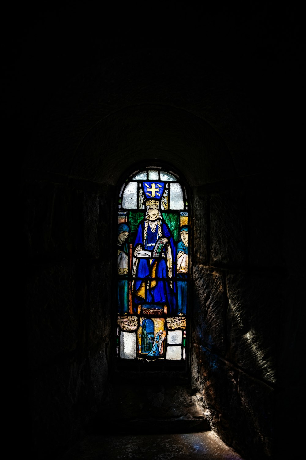 a stained glass window in a dark room