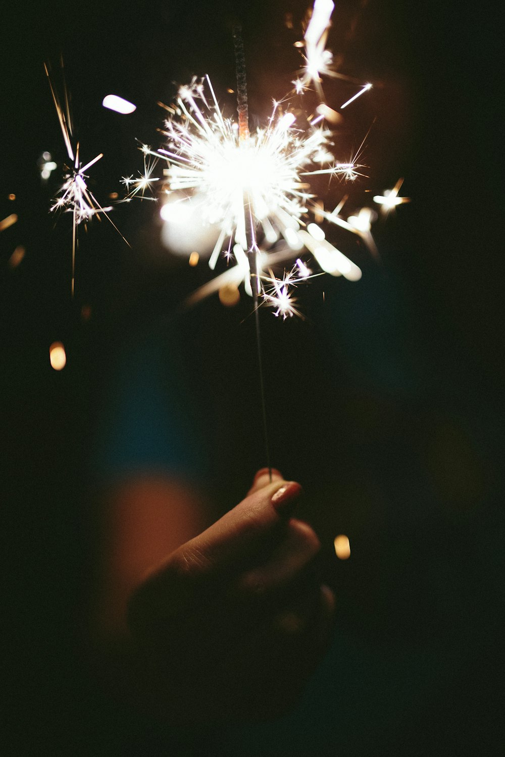 a person holding a sparkler in their hand