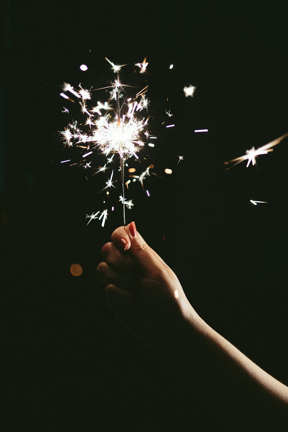 a person holding a sparkler in their hand