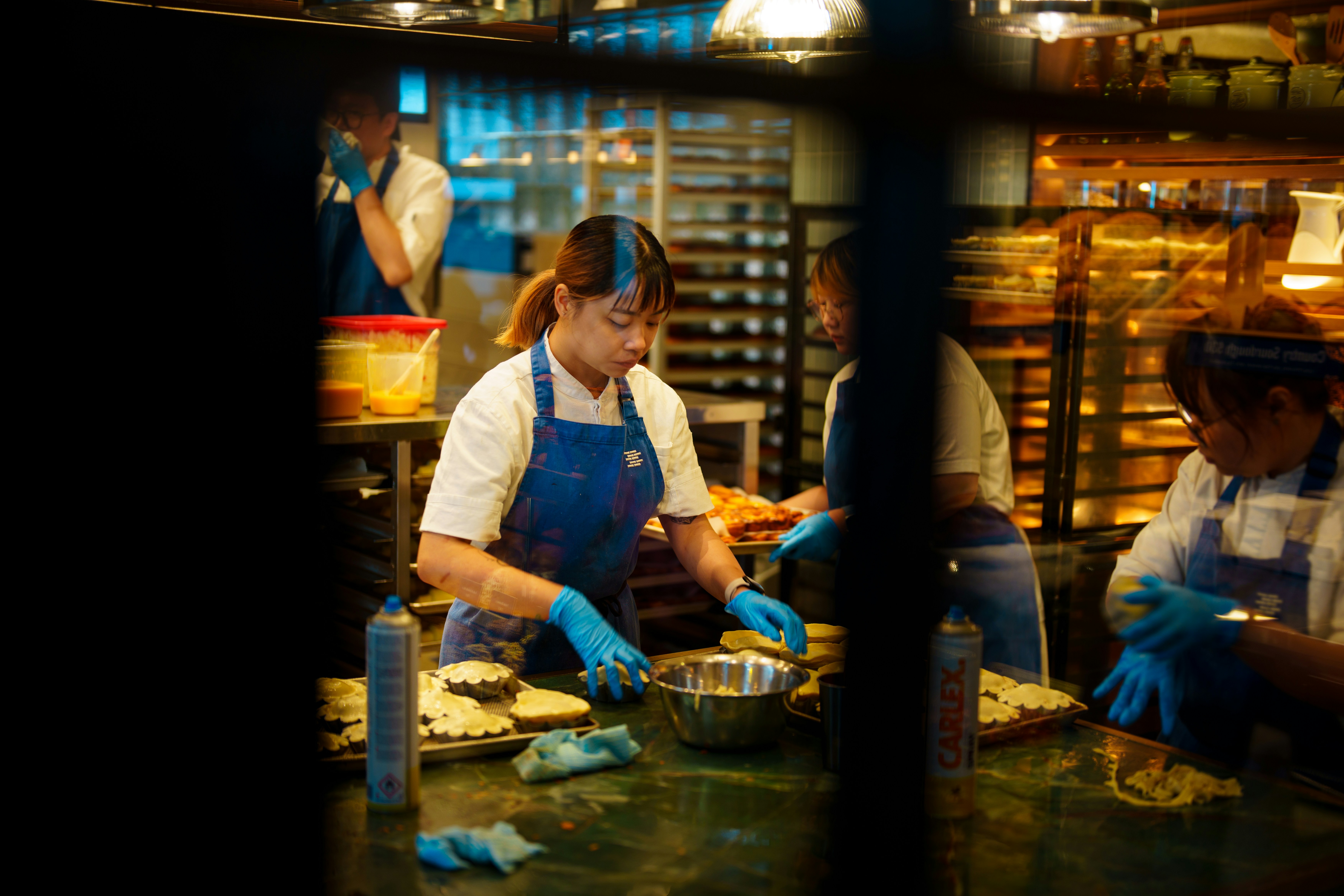 Chefs preparing food in a busy kitchen