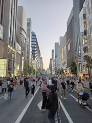 A wide pedestrian-friendly sidewalk bustling with people walking safely.