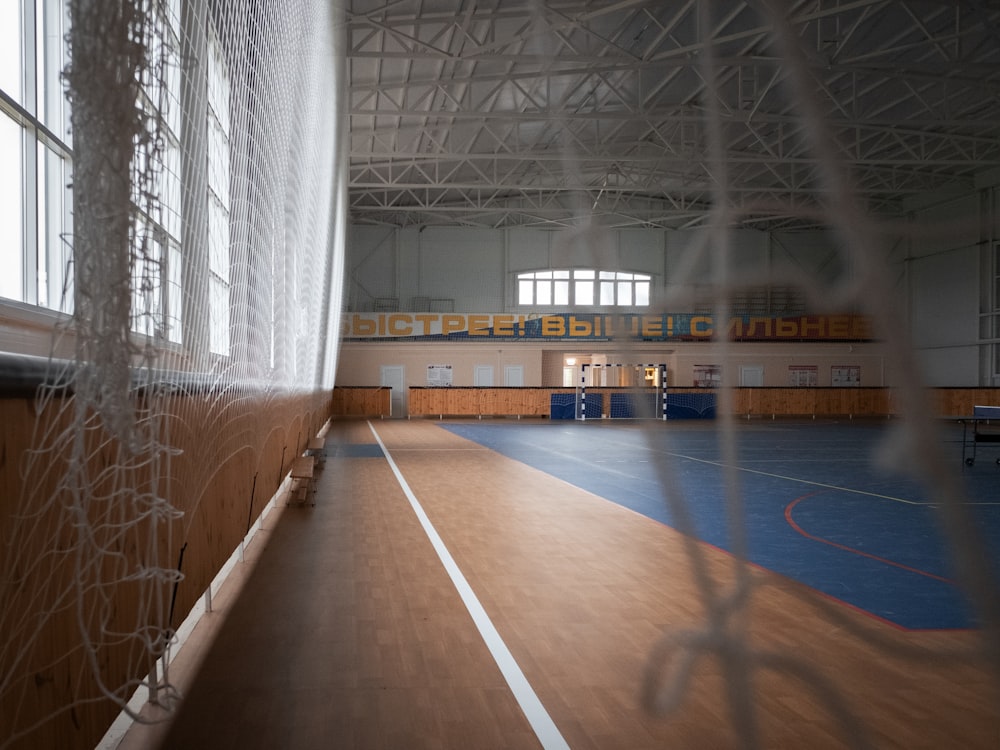 a large indoor gym with hard wood flooring