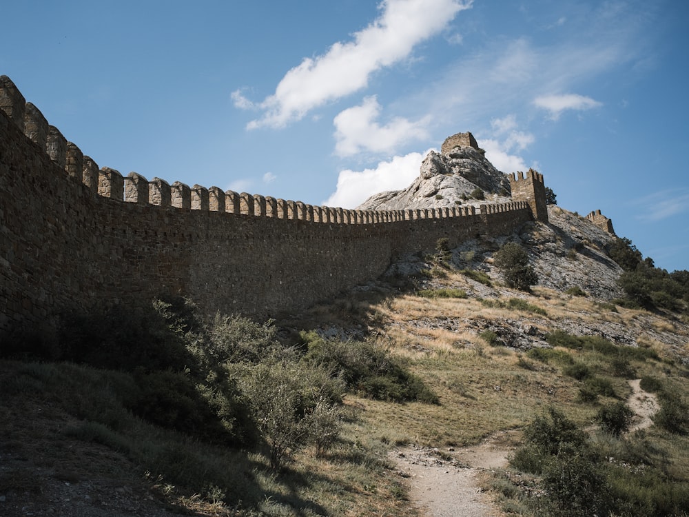 a large stone wall on top of a hill