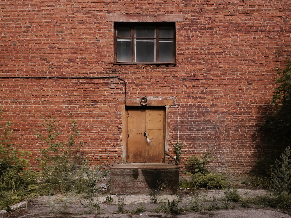 a brick building with a wooden door and window