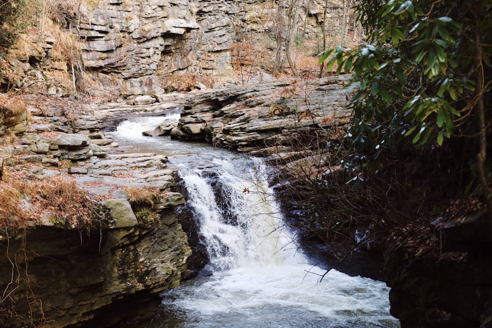 a small waterfall in the middle of a rocky area