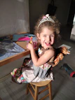 A joyful child playing with glittery slime at a sunny kitchen table