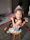 A cheerful little girl engaged in a fun occupational therapy activity with a friendly therapist.