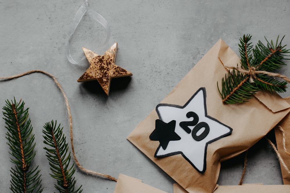 a present wrapped in brown paper next to a star ornament