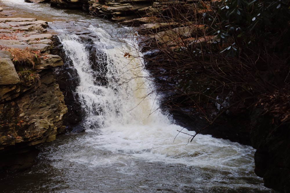 a small waterfall with water coming out of it