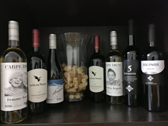 A collection of elegant wine tasting tubes arranged on a rustic wooden table, showcasing various wine colors and labels.