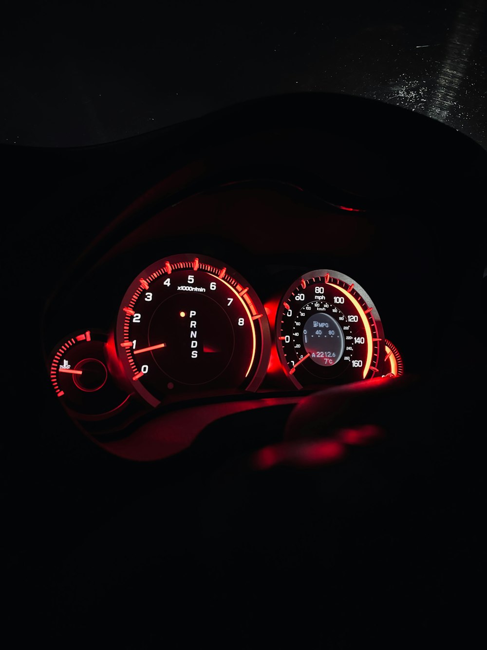 the dashboard of a car with red lights