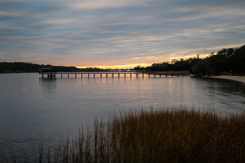 a body of water with a bridge in the distance