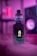 A vape device with a digital display showing the number 45 is surrounded by colorful smoke. The scene is illuminated with purple and blue lighting, giving it a modern and stylish aesthetic. The vape sits on a surface with a blurred background, emphasizing its sleek design.