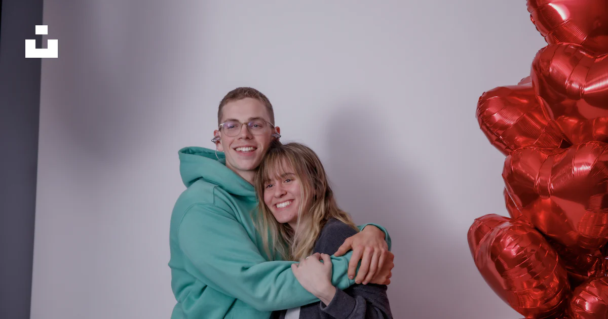 Hugging Balloons A man and a woman hugging in front of balloons photo – Free Man Image ...