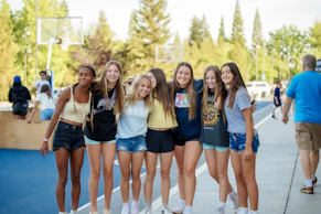 a group of young women standing next to each other
