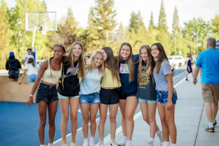 a group of young women standing next to each other