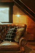 Cozy corner with a compact sofa bed styled with turquoise cushions and soft lighting.