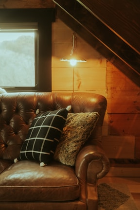 Cozy living room corner with warm lighting and stylish cushions.