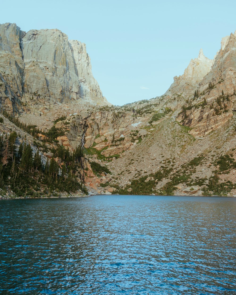 a body of water with mountains in the background