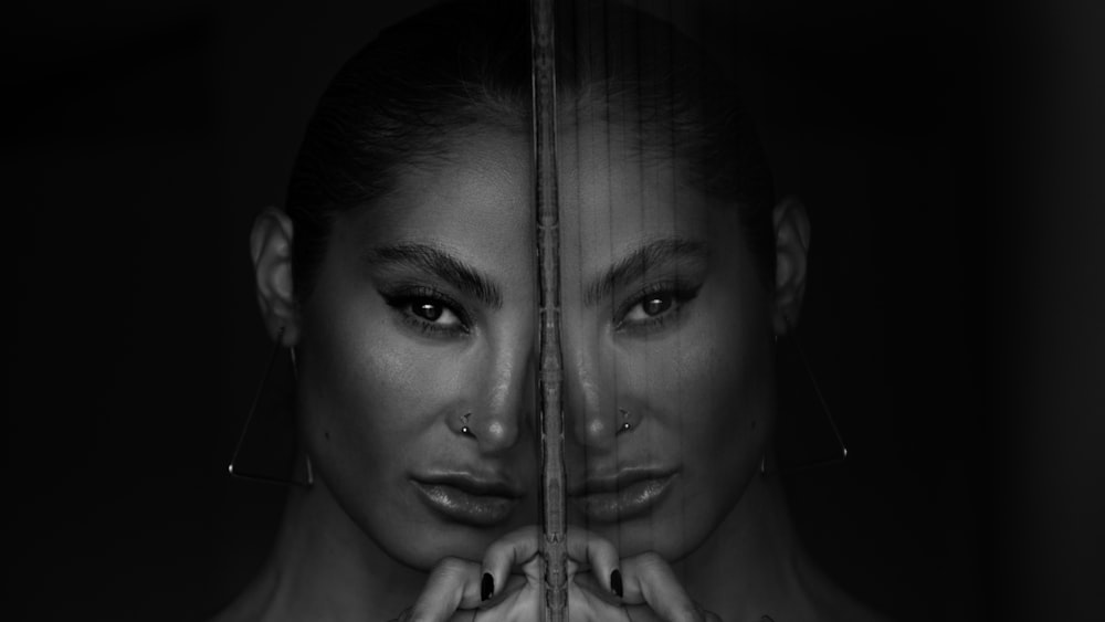 a woman with piercings on her face behind bars