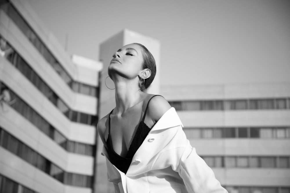 a woman standing in front of a tall building