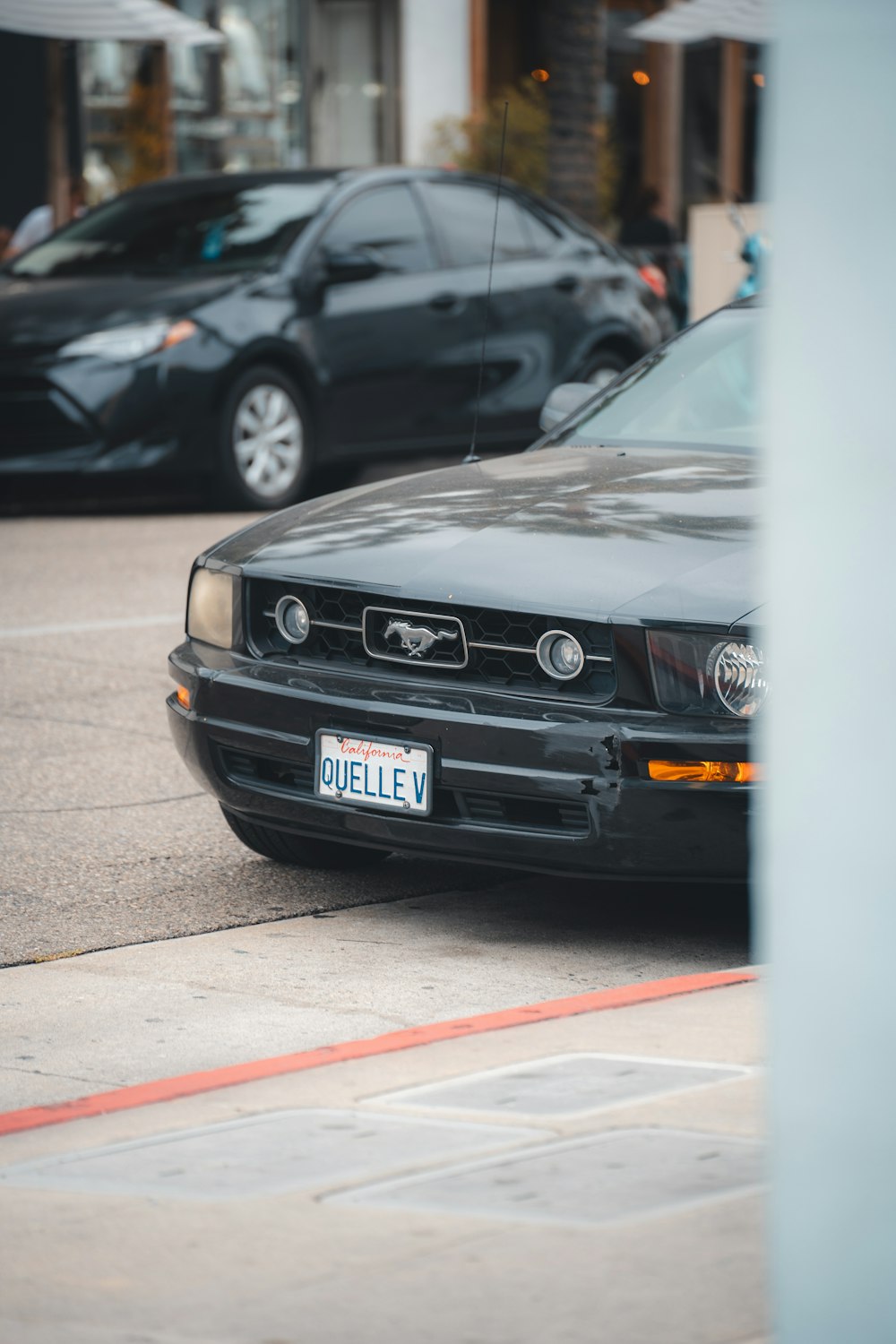 a black car parked on the side of the road