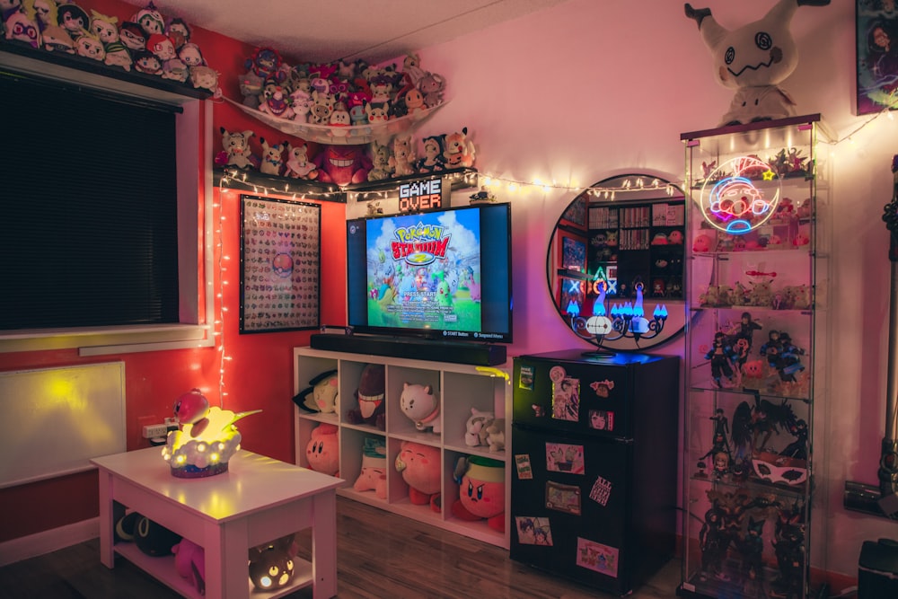 a room with a tv, shelves, and a lot of toys