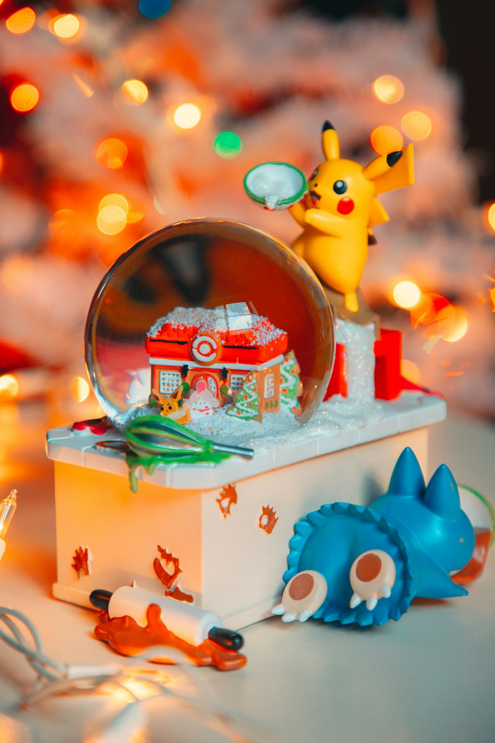 a christmas tree with a snow globe on top of it