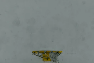 Mini basketball hoop mounted on the wall, adding a playful touch to the studio vibe.