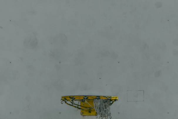 Mini basketball hoop mounted on the wall, adding a playful touch to the studio vibe.