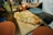 A rustic wooden table set with a delicious pizza and fresh ingredients.