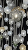 Colorful glass orbs arranged artistically on a minimalist white table.