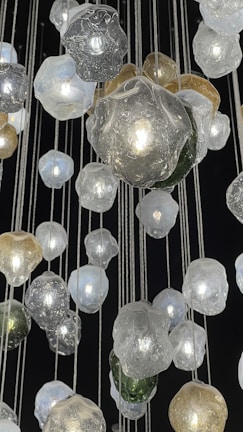 Colorful glass orbs arranged artistically on a minimalist white table.