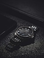 Classic watch face with intricate details and a polished metal band shining in natural light.