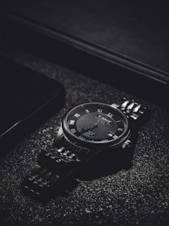 Classic watch face with intricate details and a polished metal band shining in natural light.