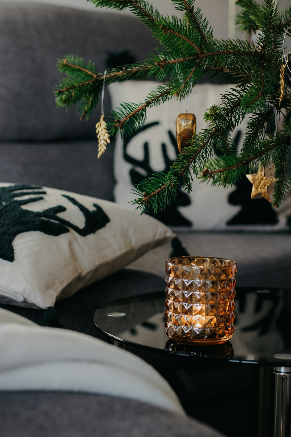 a christmas tree in a living room next to a couch