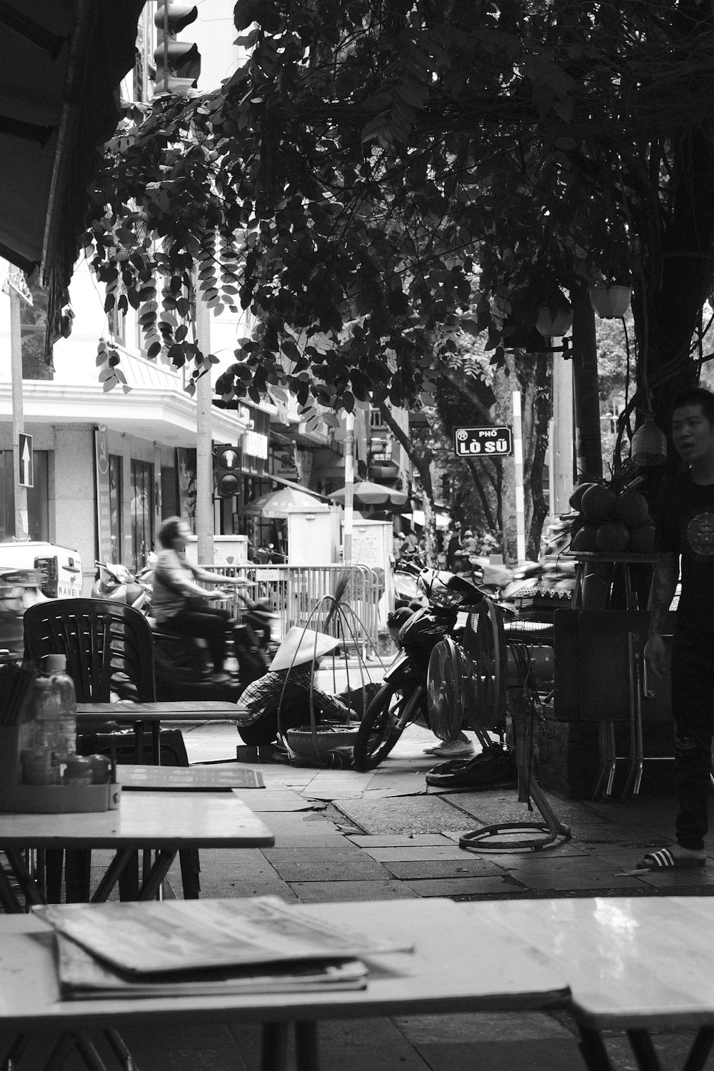 a black and white photo of people sitting at tables