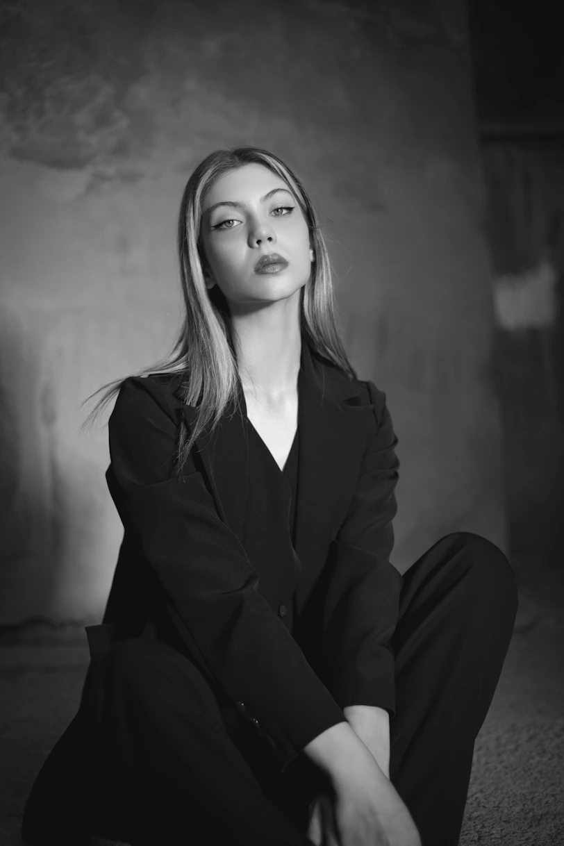 a black and white photo of a woman in a suit