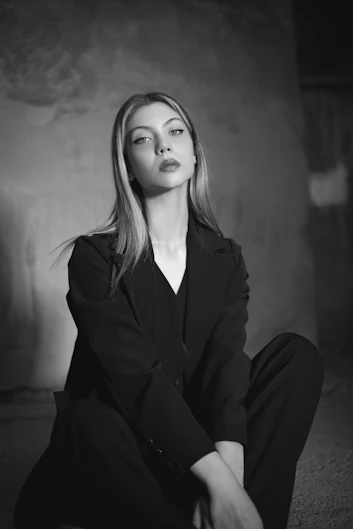 a black and white photo of a woman in a suit