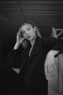 a black and white photo of a woman in a suit