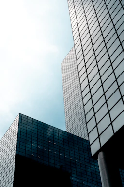 a couple of tall buildings sitting next to each other