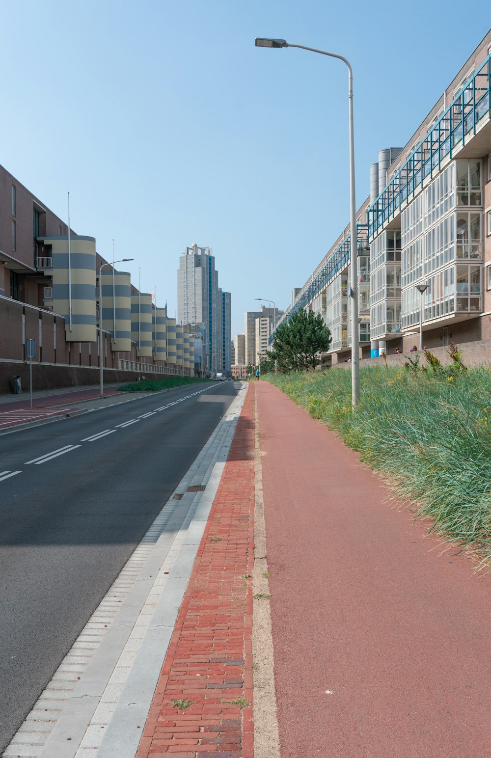 a red brick sidewalk next to a city street