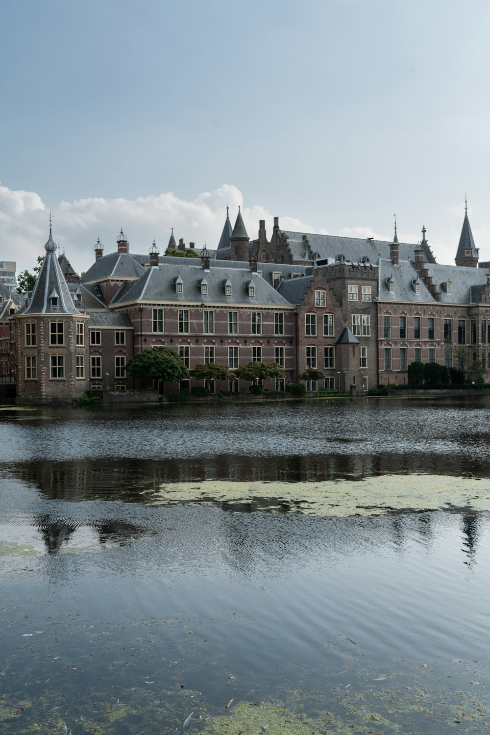 a large building sitting next to a body of water