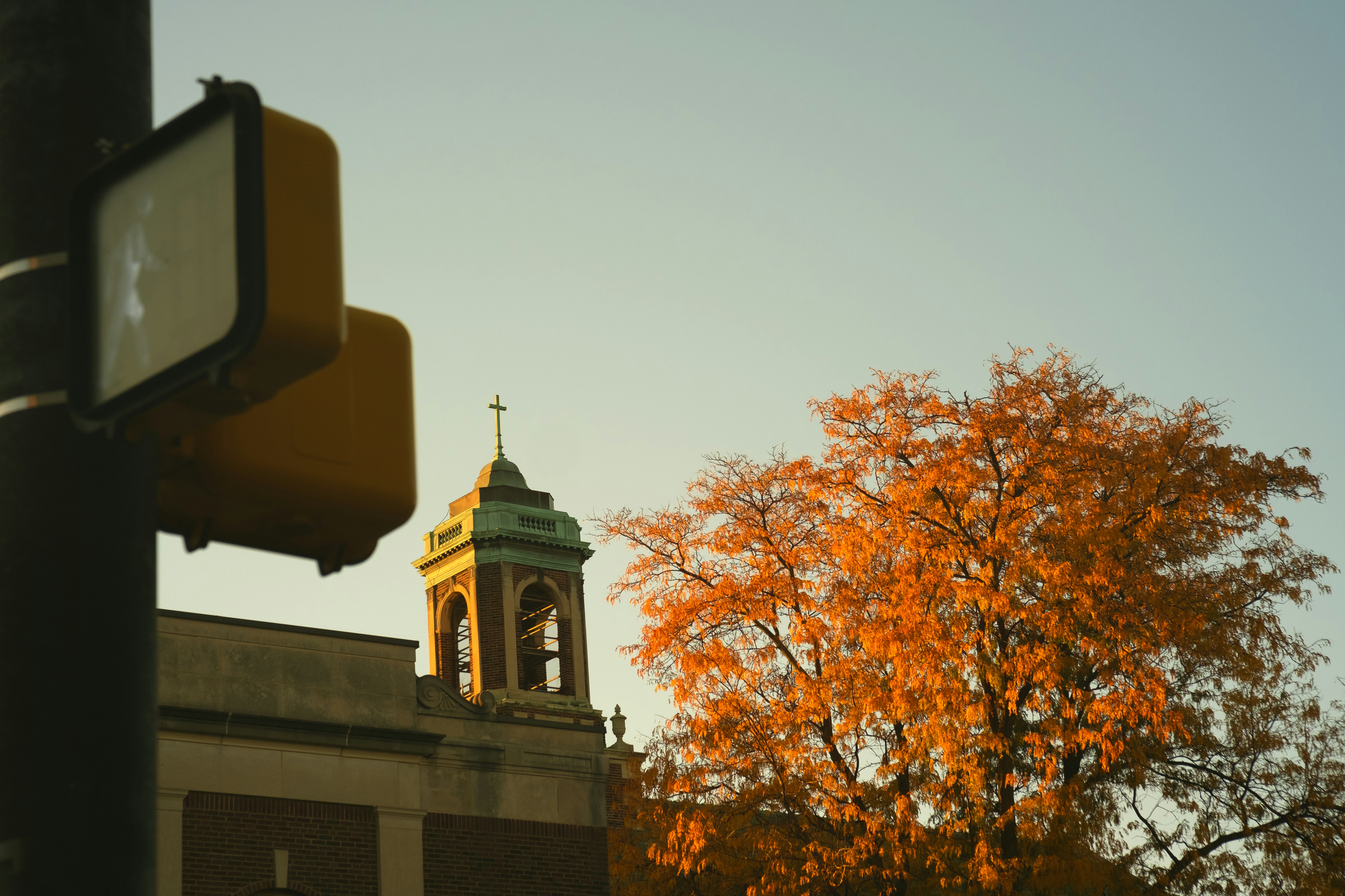 a clock tower on top of a building next to a traffic light