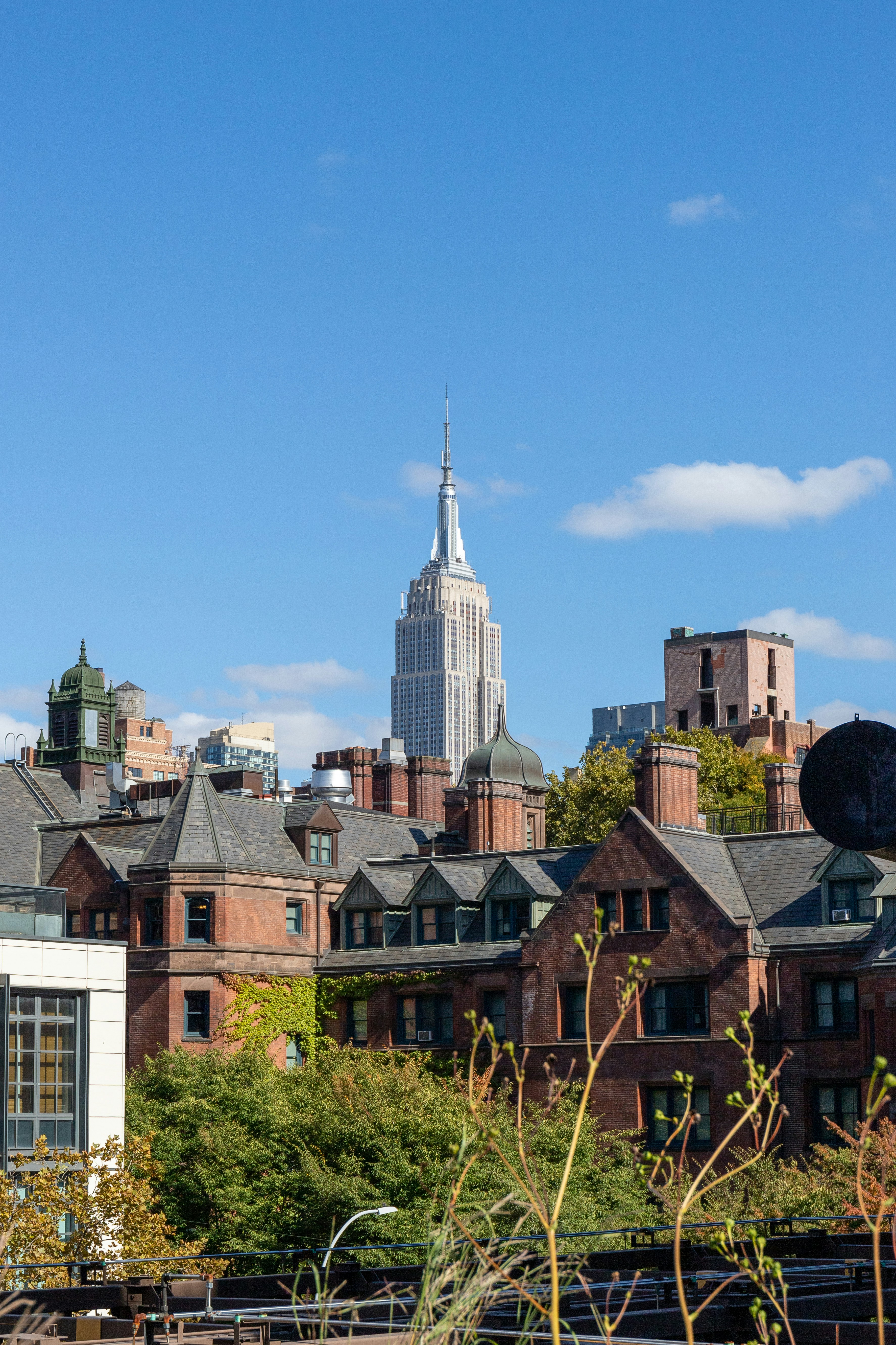 a view of a city with a tall building in the background